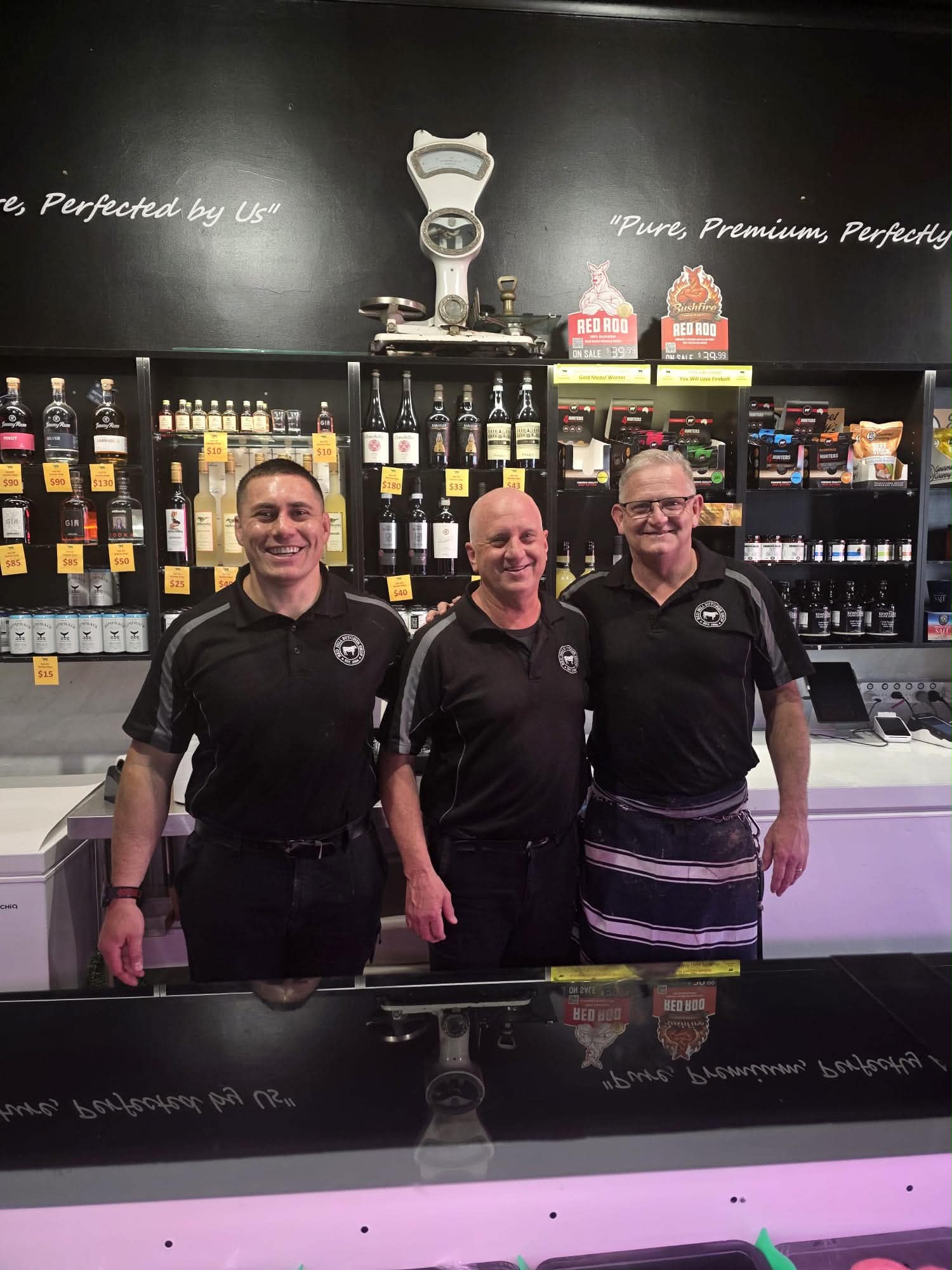 Three members of the Red Hill Butcher Shop team behind the counter
